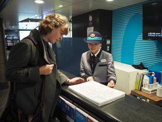 "Service Manager" assisting a passenger